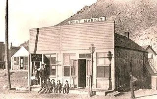 201 Bear Creek Avenue in the late 1800s with meat market sign.
