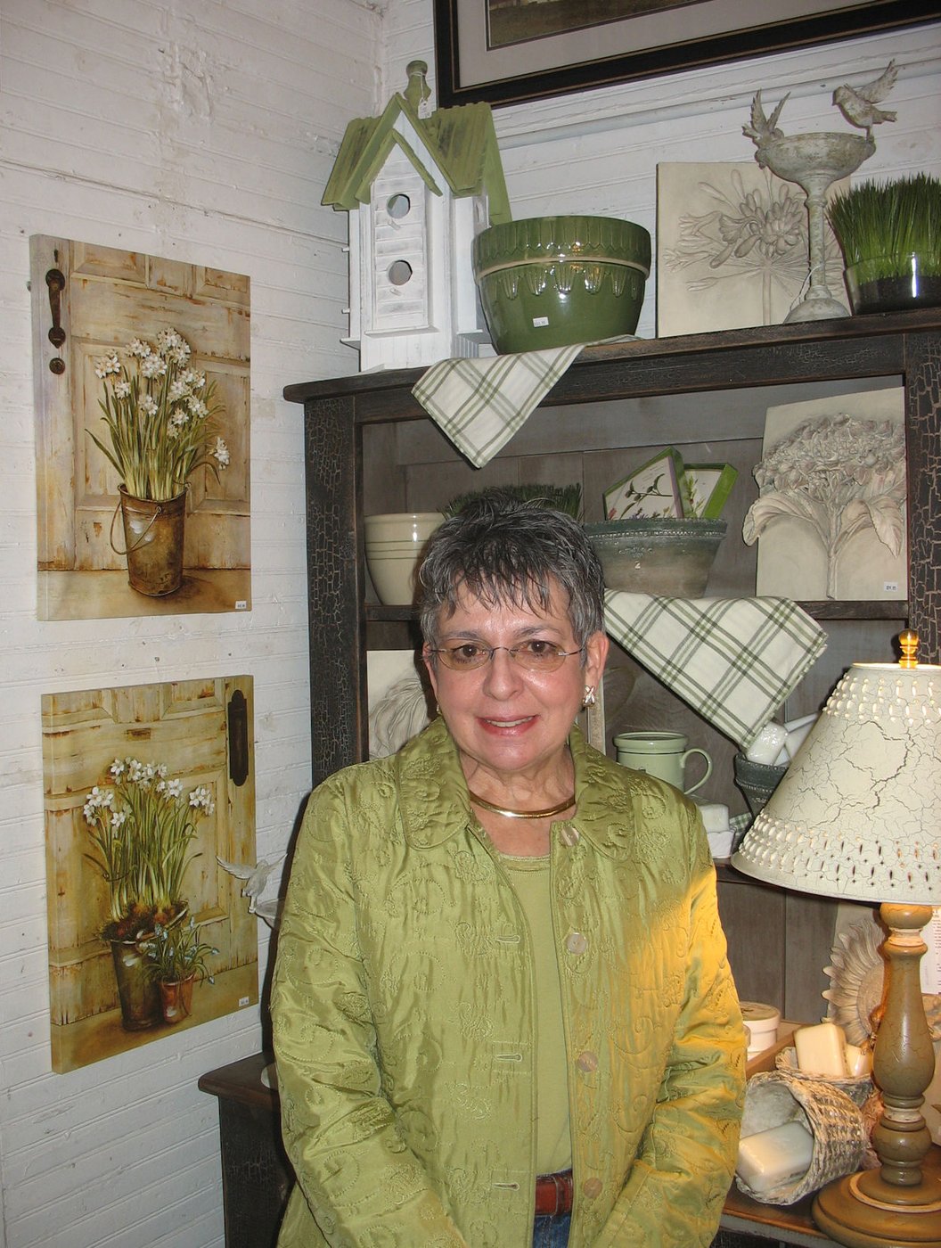 Ginny Paul beside one of the Morrison Country Store room vignettes.