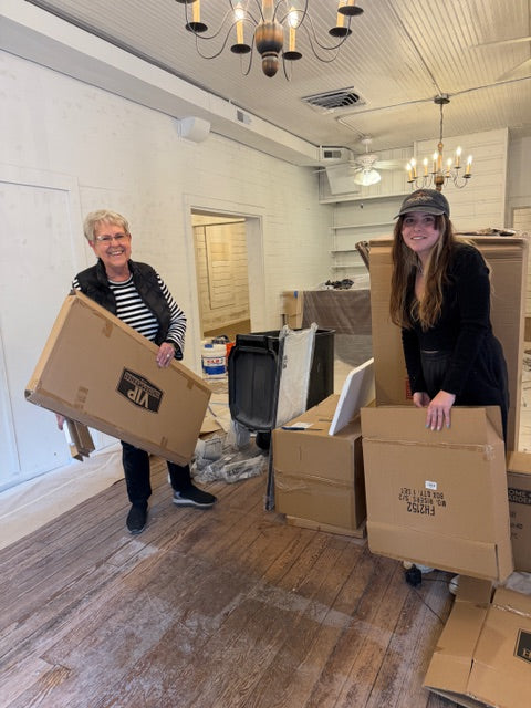 Beth and Caroline handling the first shipment of boxes inside The Little Wren Shop